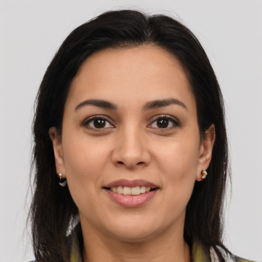 Joyful latino young-adult female with long  brown hair and brown eyes