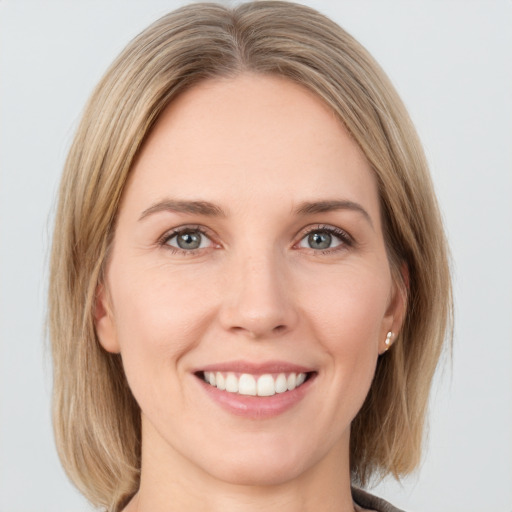 Joyful white young-adult female with medium  brown hair and green eyes