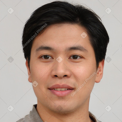 Joyful asian young-adult male with short  brown hair and brown eyes