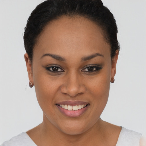 Joyful black young-adult female with short  brown hair and brown eyes