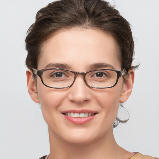 Joyful white young-adult female with medium  brown hair and grey eyes