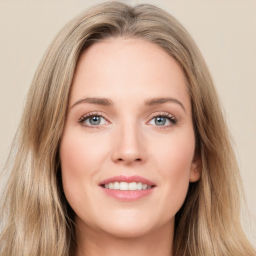 Joyful white young-adult female with long  brown hair and green eyes