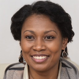 Joyful black adult female with medium  brown hair and brown eyes