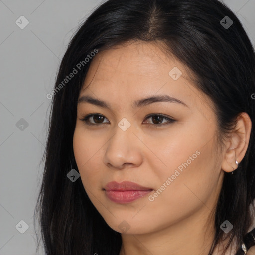 Joyful latino young-adult female with long  brown hair and brown eyes