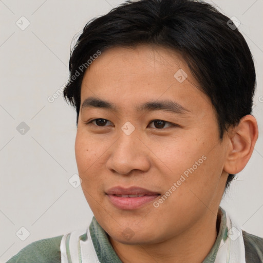 Joyful asian young-adult male with short  brown hair and brown eyes