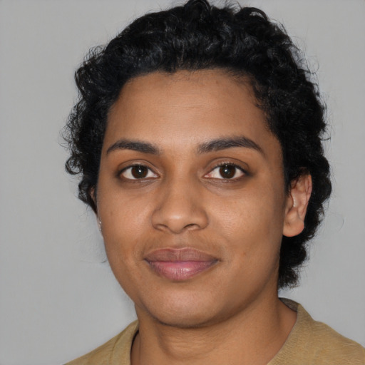 Joyful black young-adult female with short  black hair and brown eyes