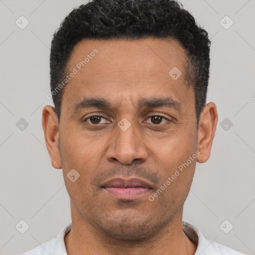 Joyful latino adult male with short  black hair and brown eyes