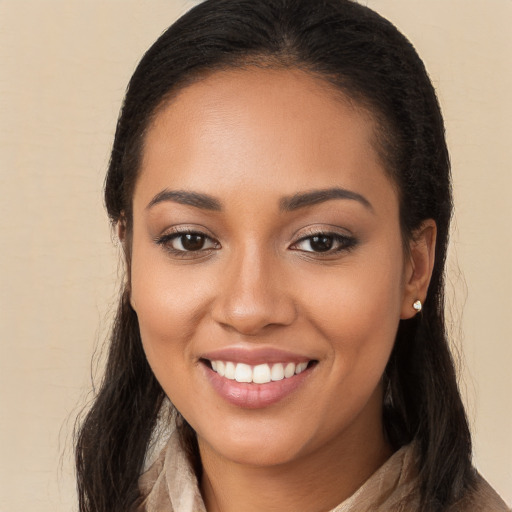 Joyful latino young-adult female with long  brown hair and brown eyes