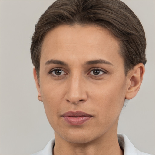 Joyful white young-adult female with short  brown hair and brown eyes