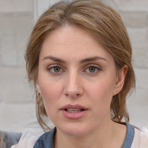 Joyful white young-adult female with medium  brown hair and blue eyes