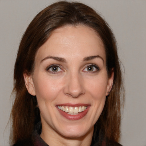 Joyful white adult female with medium  brown hair and brown eyes