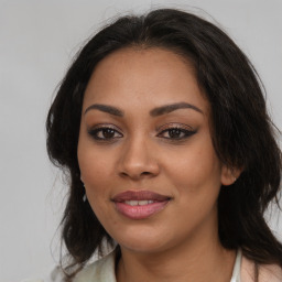 Joyful latino young-adult female with medium  brown hair and brown eyes