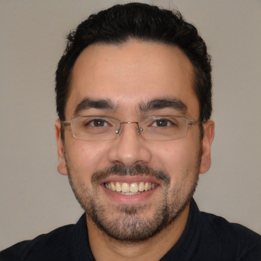 Joyful white young-adult male with short  black hair and brown eyes