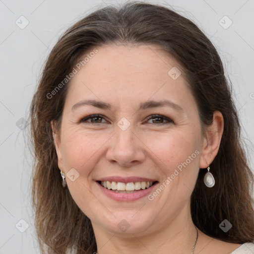 Joyful white adult female with medium  brown hair and grey eyes