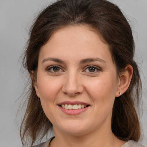 Joyful white young-adult female with medium  brown hair and brown eyes