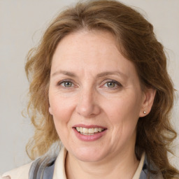 Joyful white adult female with medium  brown hair and grey eyes