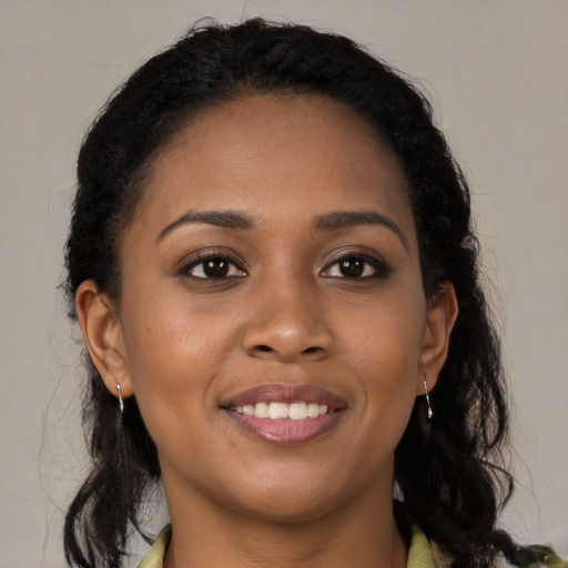 Joyful black young-adult female with medium  brown hair and brown eyes
