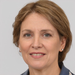 Joyful white adult female with medium  brown hair and grey eyes