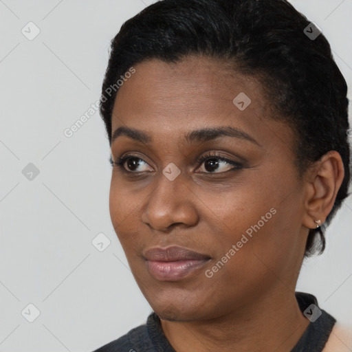 Joyful black young-adult female with short  black hair and brown eyes