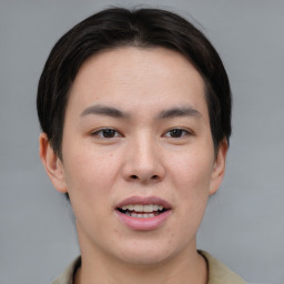 Joyful asian young-adult male with short  brown hair and brown eyes