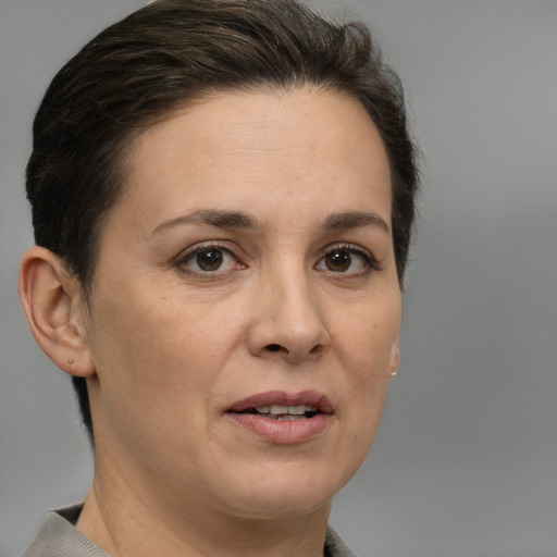 Joyful white adult female with short  brown hair and brown eyes