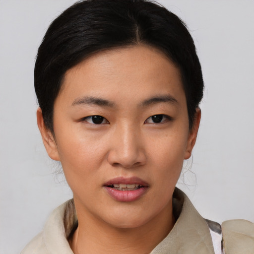 Joyful asian young-adult female with short  black hair and brown eyes