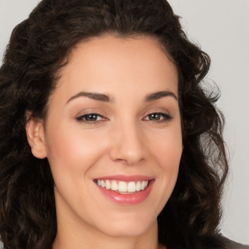 Joyful white young-adult female with long  brown hair and brown eyes