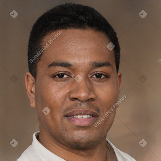 Joyful latino young-adult male with short  brown hair and brown eyes