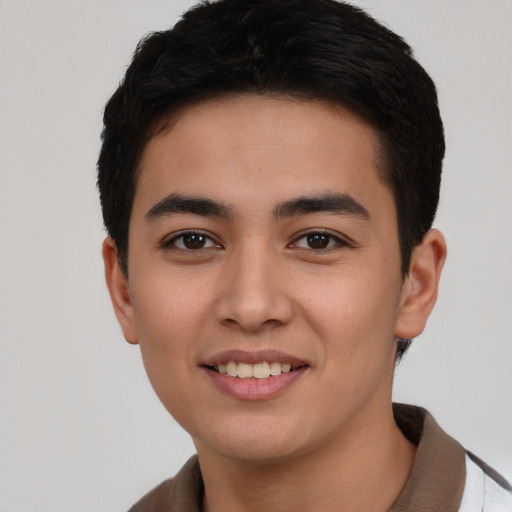 Joyful asian young-adult male with short  brown hair and brown eyes