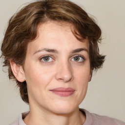 Joyful white young-adult female with medium  brown hair and green eyes