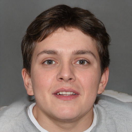 Joyful white young-adult male with short  brown hair and blue eyes