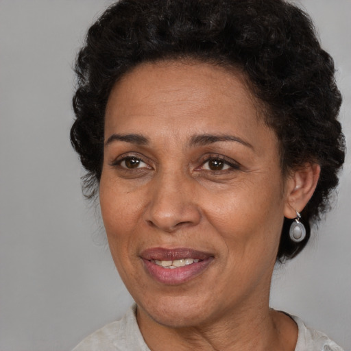 Joyful latino adult female with short  brown hair and brown eyes