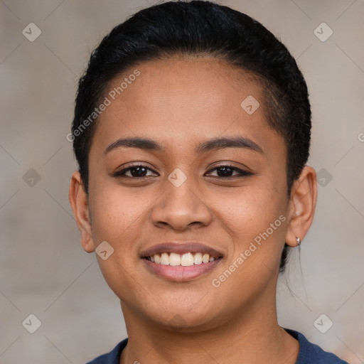 Joyful latino young-adult female with short  black hair and brown eyes