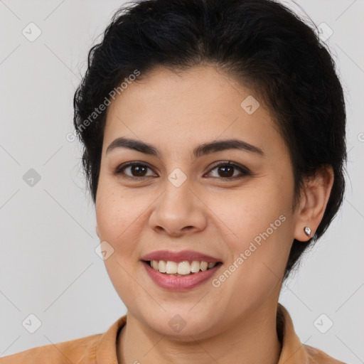 Joyful latino young-adult female with short  brown hair and brown eyes