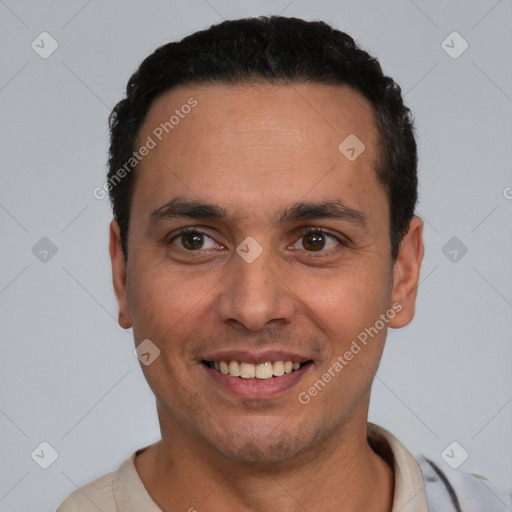 Joyful latino young-adult male with short  black hair and brown eyes