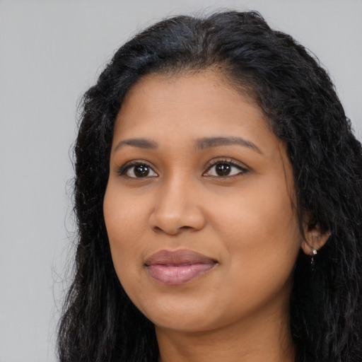Joyful latino young-adult female with long  black hair and brown eyes