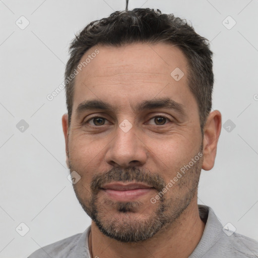 Joyful white adult male with short  black hair and brown eyes