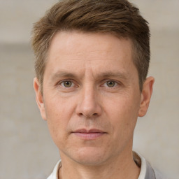 Joyful white adult male with short  brown hair and grey eyes