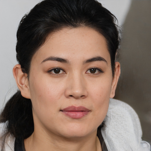 Joyful asian young-adult female with medium  brown hair and brown eyes