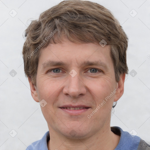 Joyful white adult male with short  brown hair and grey eyes