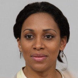 Joyful black adult female with short  brown hair and brown eyes