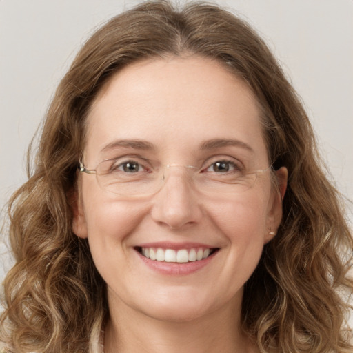 Joyful white young-adult female with long  brown hair and green eyes