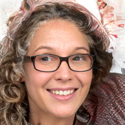 Joyful white adult female with medium  brown hair and blue eyes