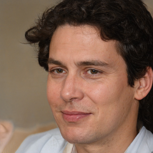 Joyful white adult male with medium  brown hair and brown eyes