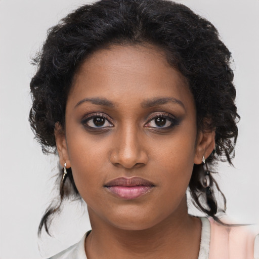 Joyful black young-adult female with medium  brown hair and brown eyes