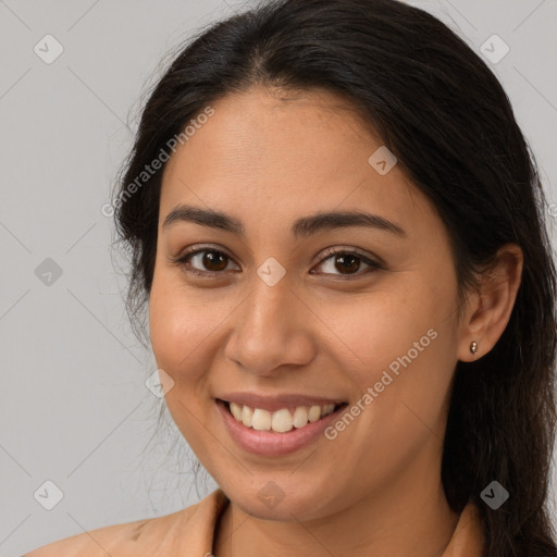 Joyful latino young-adult female with long  brown hair and brown eyes