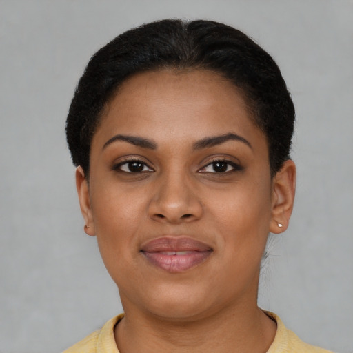 Joyful latino young-adult female with short  black hair and brown eyes