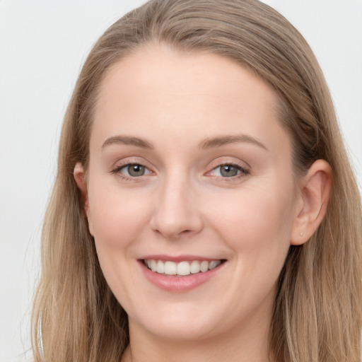 Joyful white young-adult female with long  brown hair and blue eyes