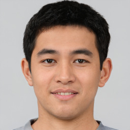 Joyful asian young-adult male with short  black hair and brown eyes