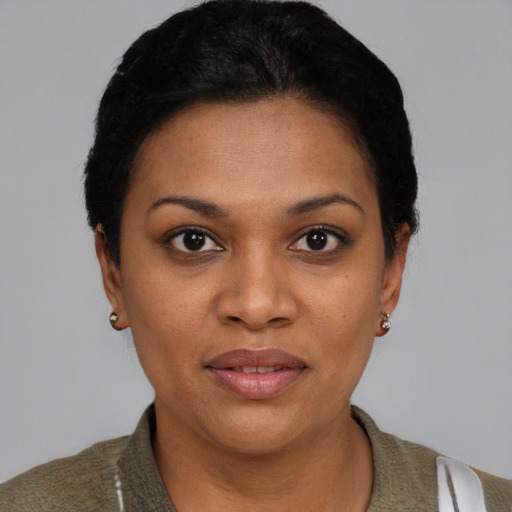 Joyful black young-adult female with short  black hair and brown eyes
